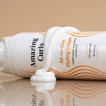 Witte tube All-in-One Styling Cream met oranje golvende lijnen en witte crème die krullen definieert en hydrateert.